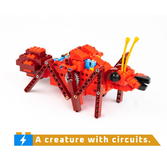 Toy creature made of interlocking bricks with visible circuits on a white background