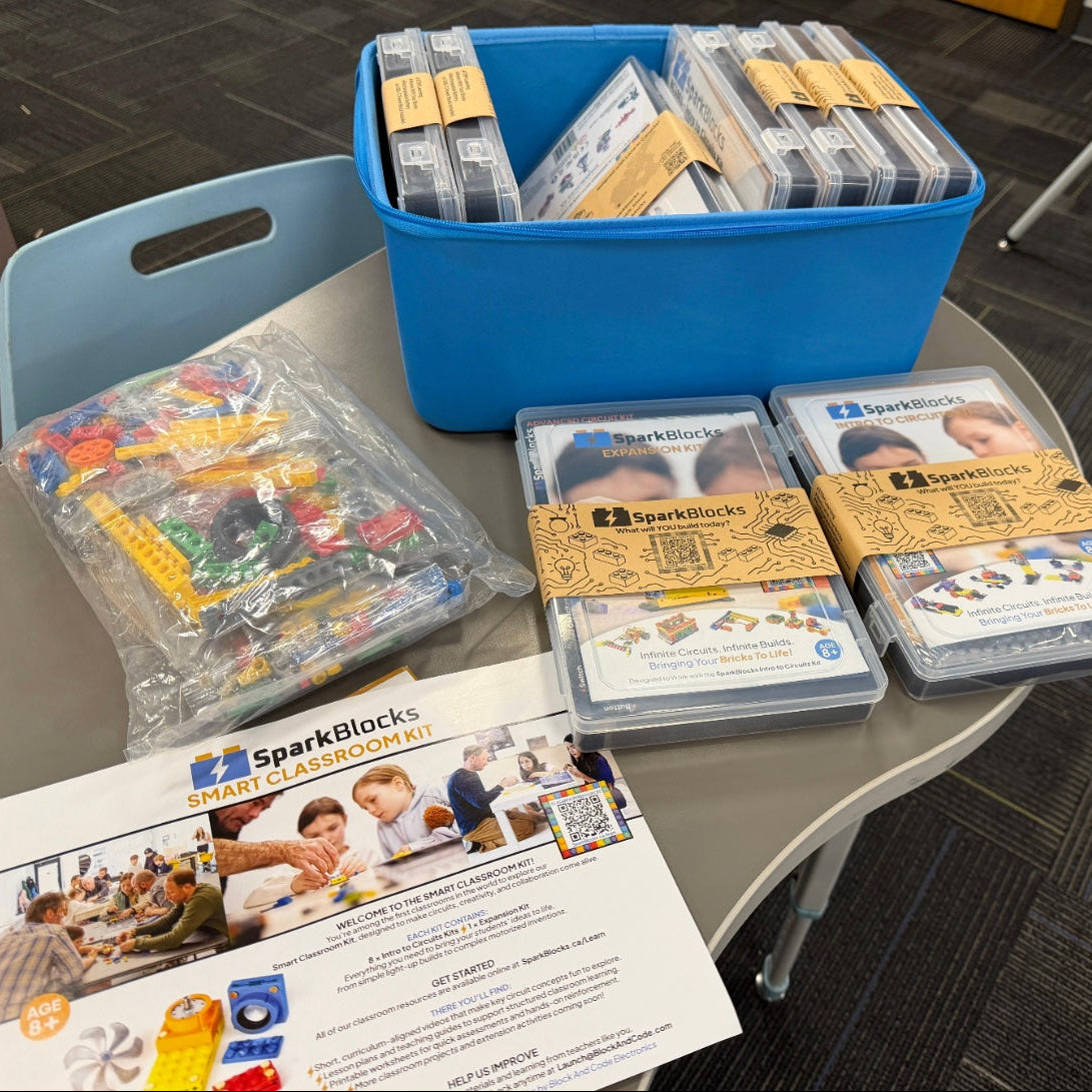 Educational materials including SparkBlocks on a table in a classroom setting.
