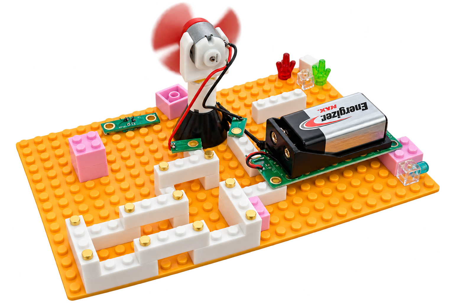 A toy-built circuit board model on an orange baseplate, featuring a small white and red fan, a black Energizer 9V battery, white and pink brick walls, and electronic components on a white background.